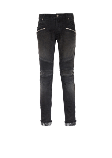 Jeans slim-fit in cotone effetto sbiadito e increspato con monogramma Balmain sull’orlo